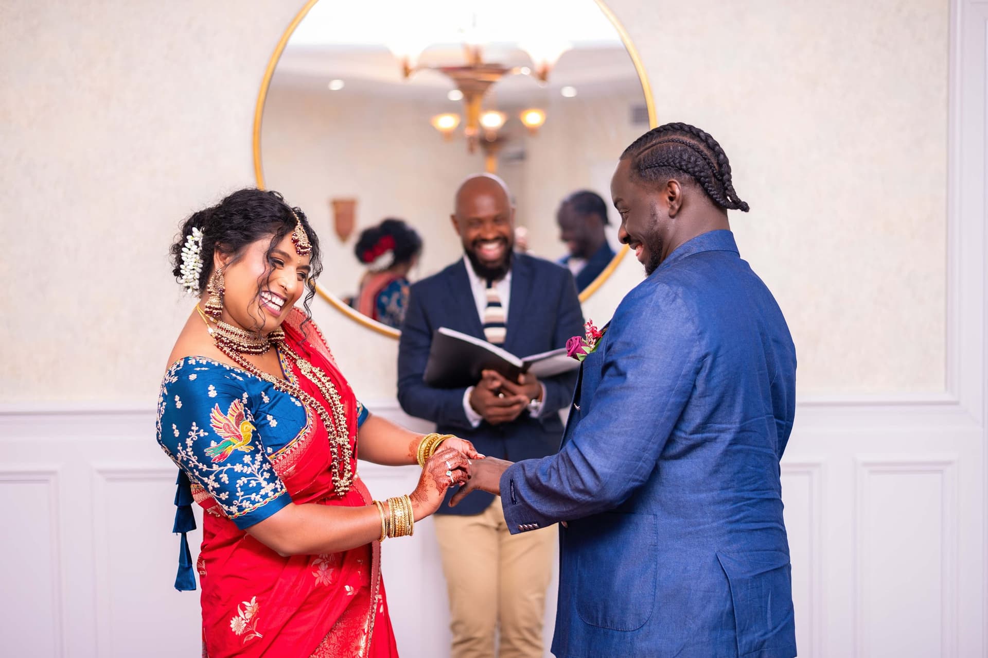 She laughs as the ring goes on; he watches his own hand.